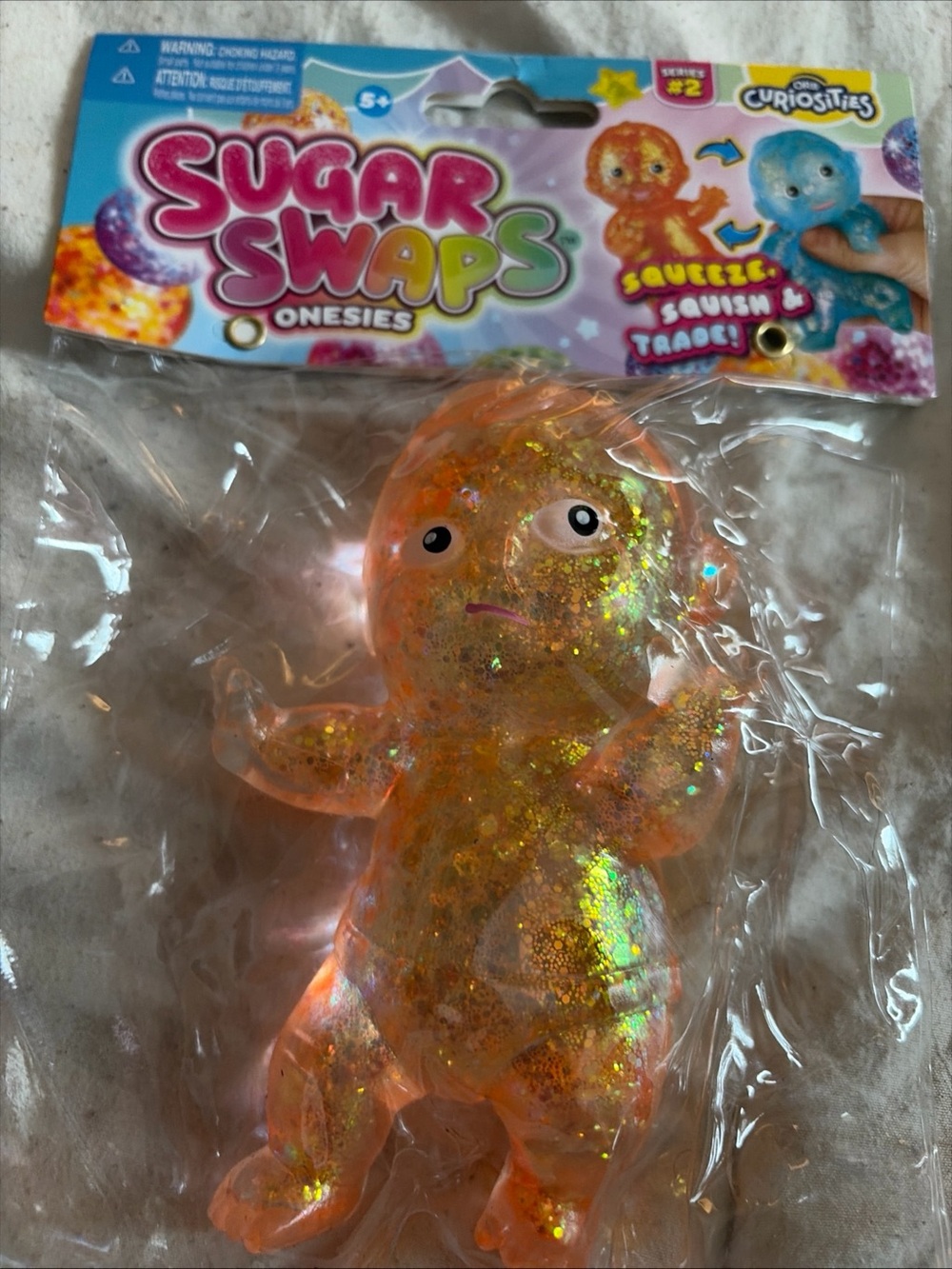 Sugar Swaps Onesies Glitter Squishy Toy - Orange